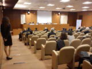 Support hostess in conference room with wireless radio microphone for questions from the audience
